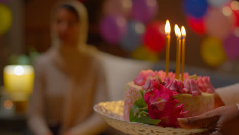 Close-Up-Of-Multi-Cultural-Friends-Giving-Woman-Birthday-Cake-With-Candles-At-Party-At-Home